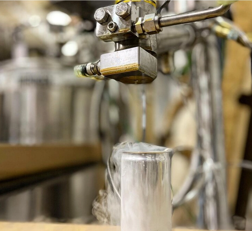 A machine is pouring liquid into a cup.